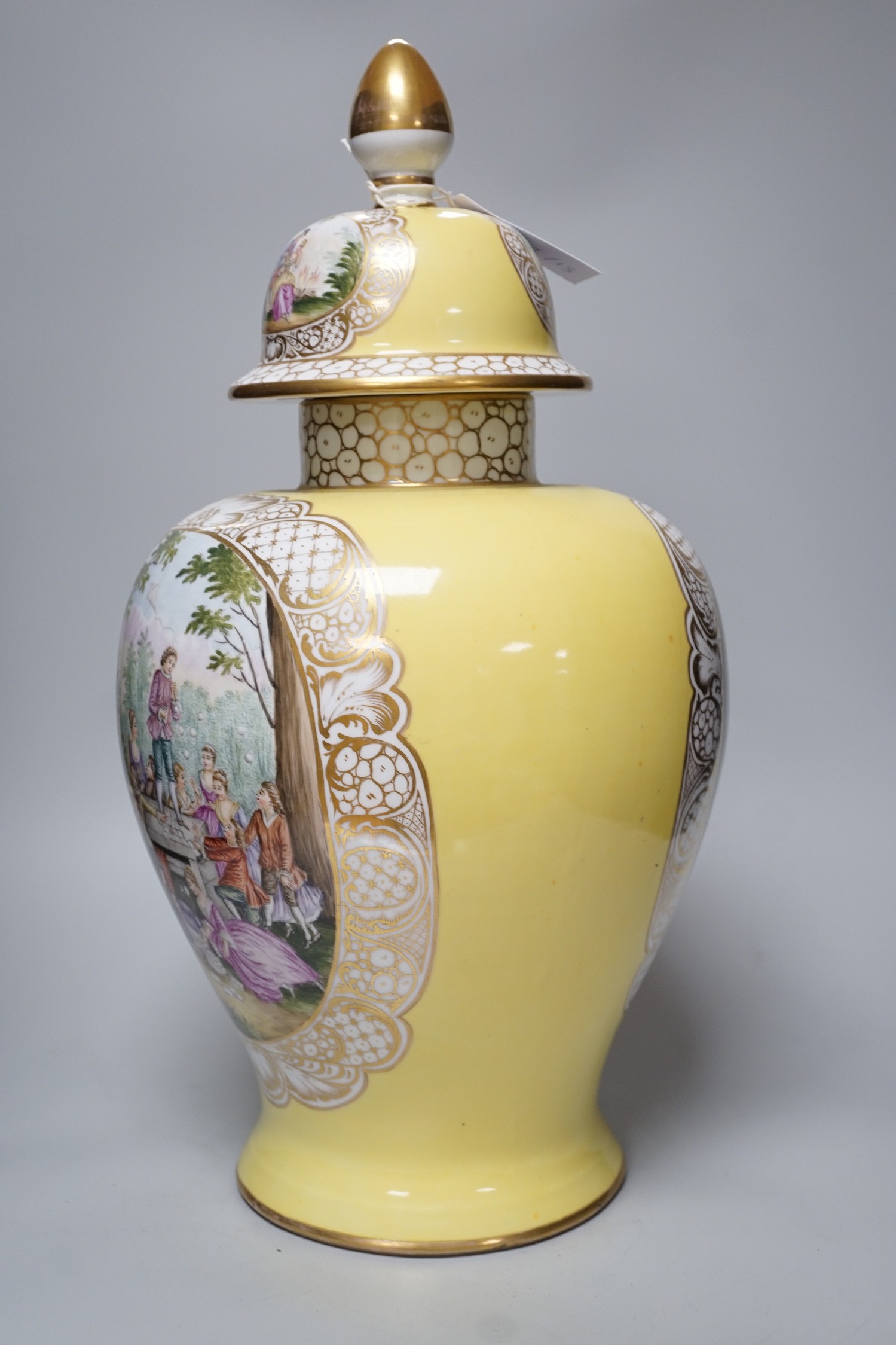 A large Helena Wolfsohn, Dresden vase and cover, from 1880, with a painted figural fishing cartouche one side and leisure activities the other, 52cms high